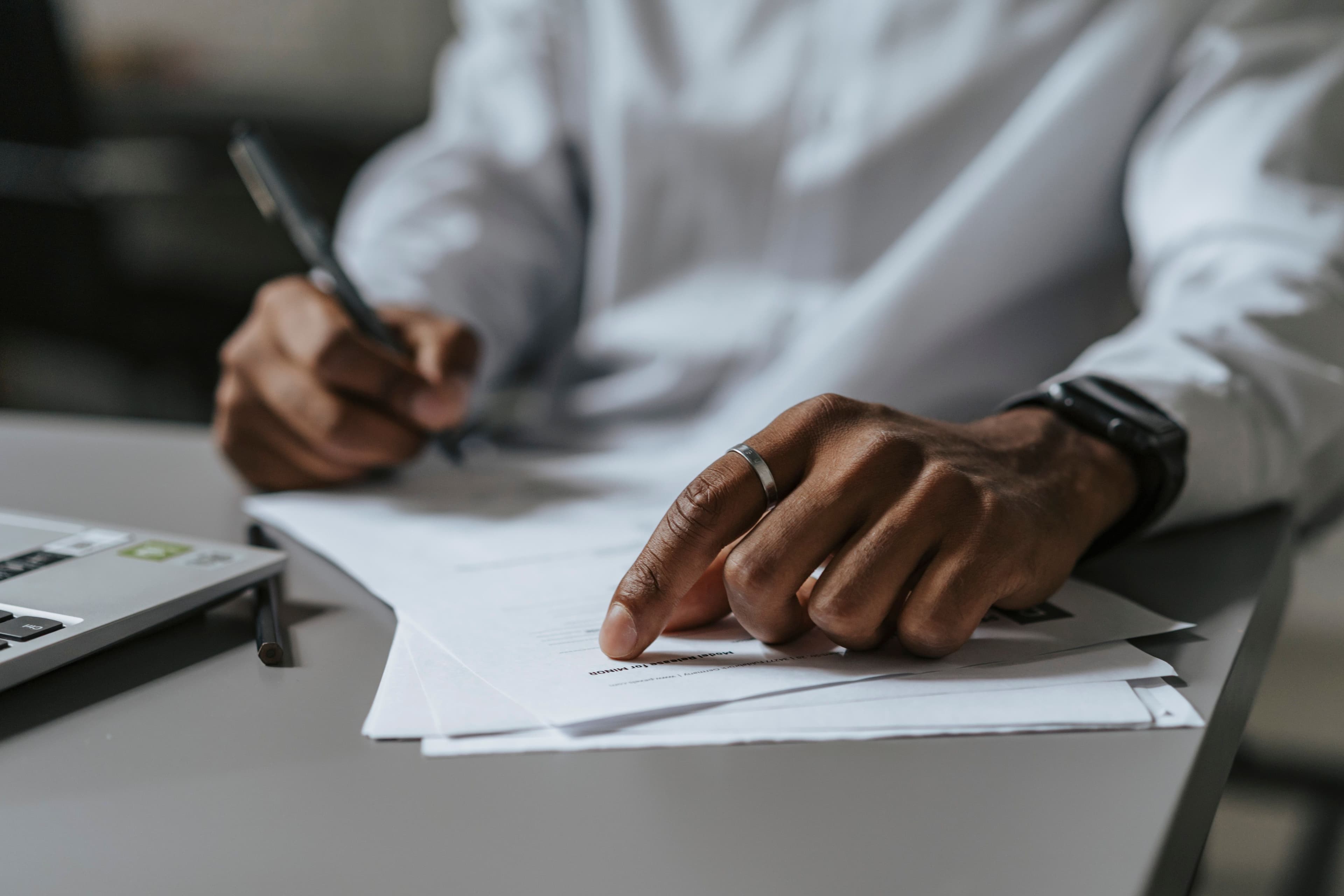 Person reviewing paperwork at a desk
