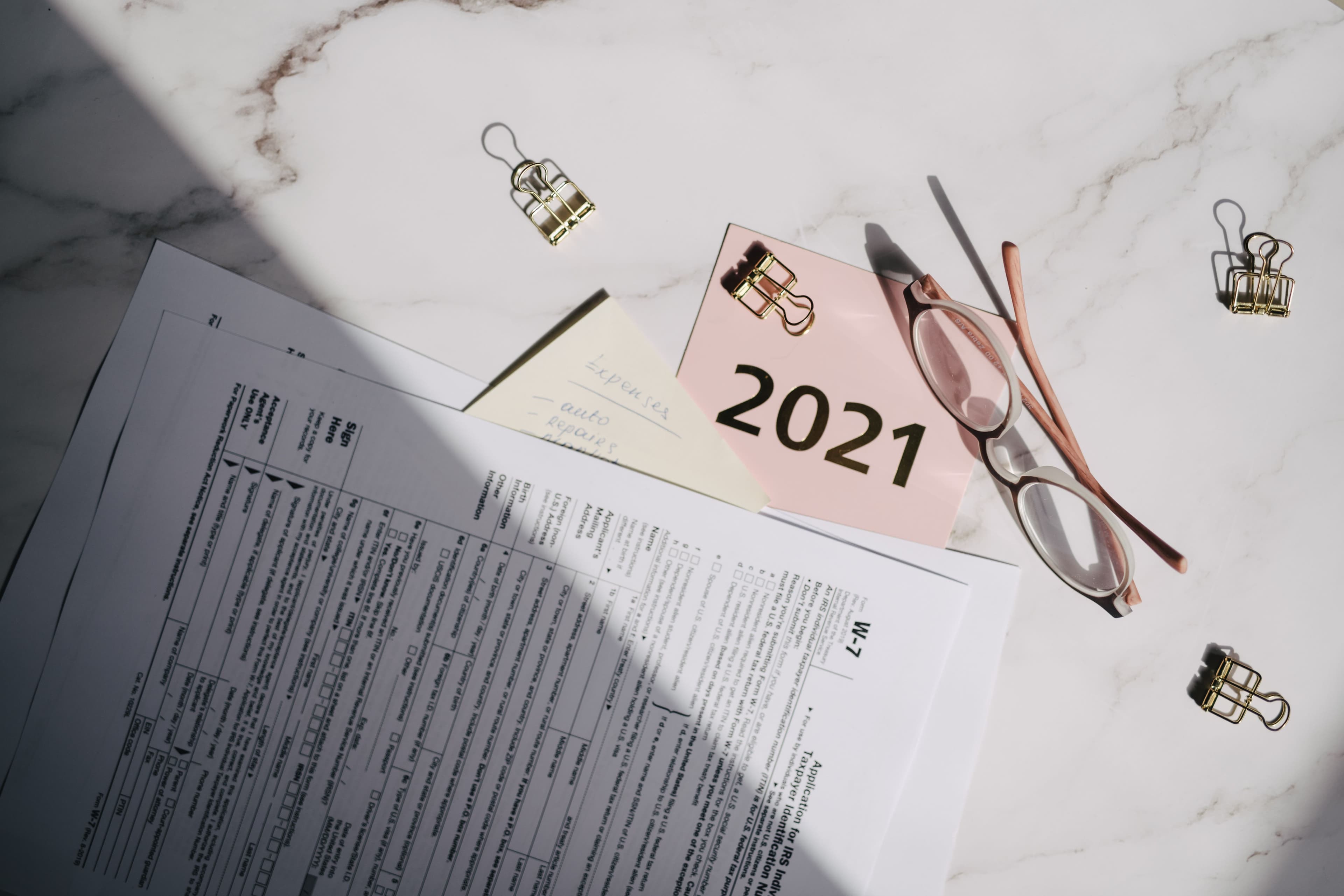 Financial documents and dated 2021 note on a desk